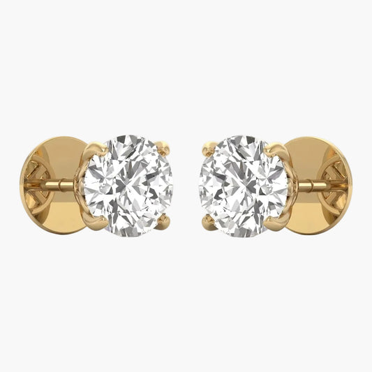 Gold earrings with clear gemstones on a white background