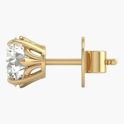 Gold earring with a clear gemstone on a light gray background