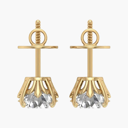 Gold earrings with clear gemstones on a white background