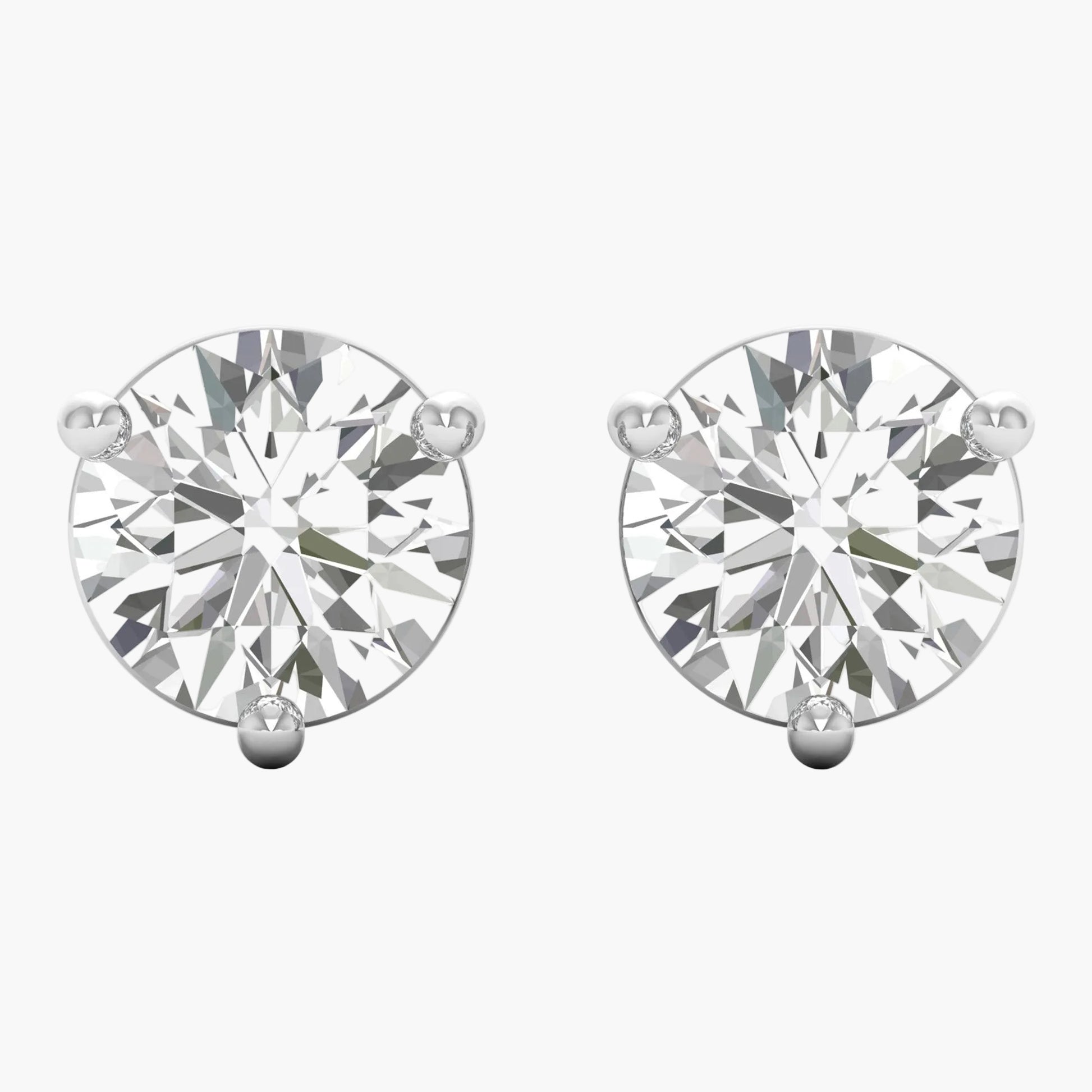 Pair of diamond stud earrings on a white background