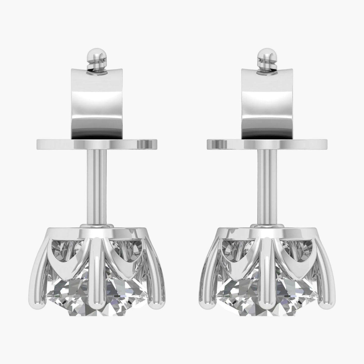 Pair of silver earrings with intricate designs on a white background