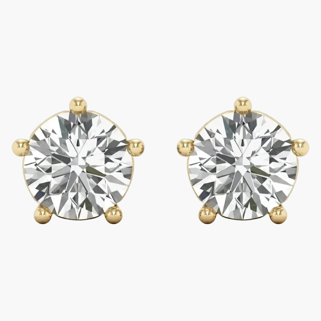 A pair of round-cut diamond stud earrings in yellow gold four-prong settings, shown against a plain light gray background.