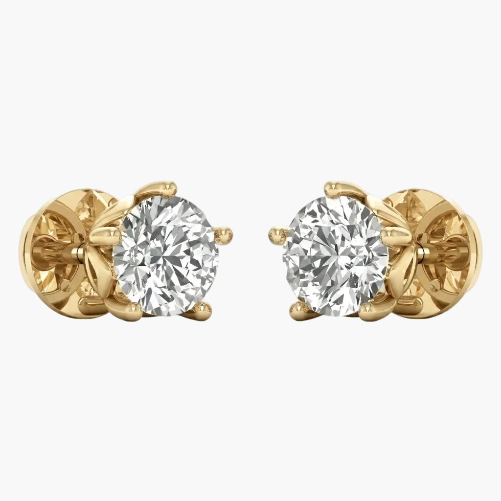 A pair of yellow gold stud earrings, each featuring a round brilliant-cut clear gemstone in a prong setting, shown against a plain light gray background.