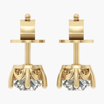 A pair of gold stud earrings with a geometric crown design and a clear faceted gemstone at the bottom, shown on a light gray background.