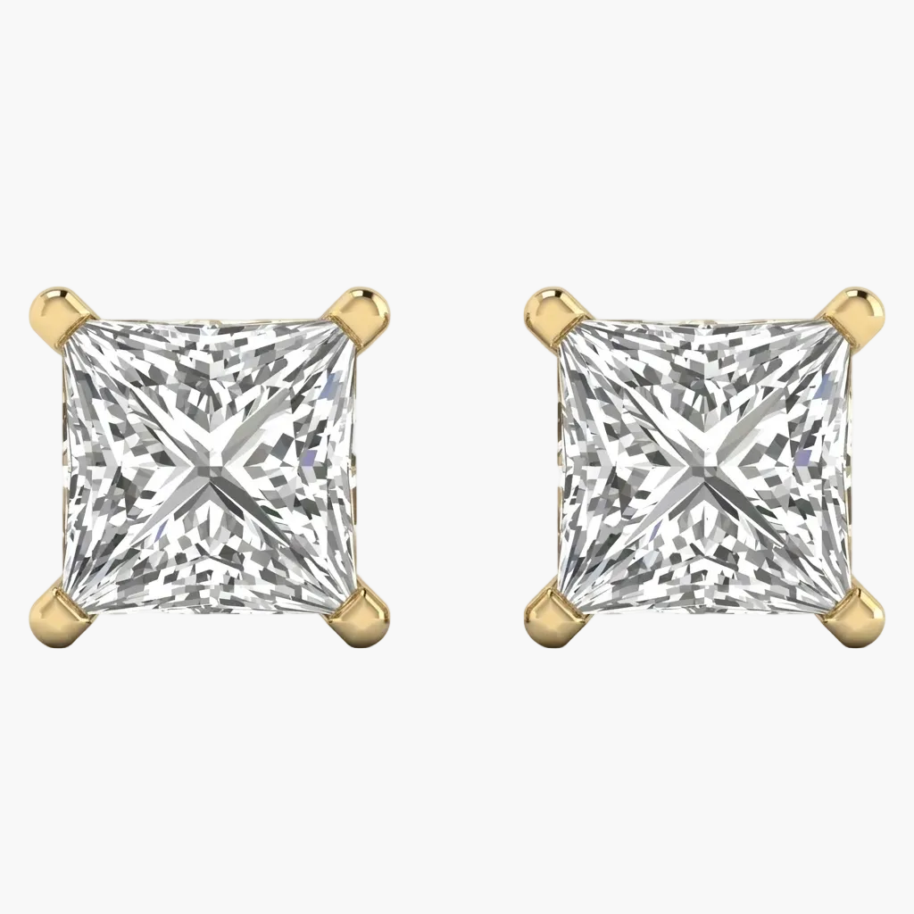 Pair of gold earrings with clear gemstones on a white background