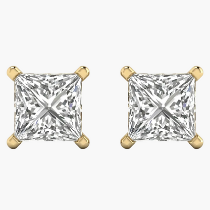 Pair of gold earrings with clear gemstones on a white background