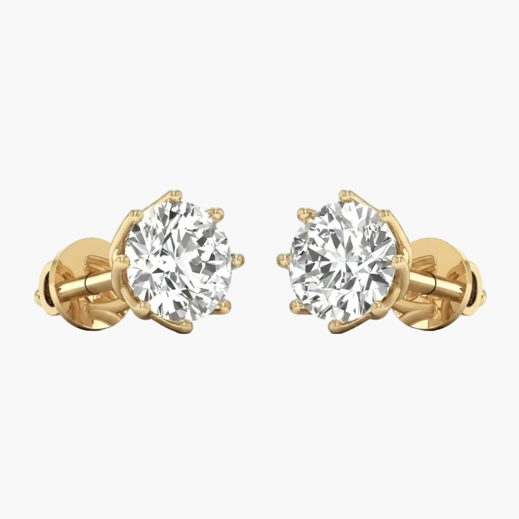 A pair of yellow gold stud earrings with round brilliant-cut clear gemstones in a prong setting, shown on a plain white background.