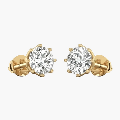 A pair of yellow gold stud earrings with round brilliant-cut clear gemstones in a prong setting, shown on a plain white background.