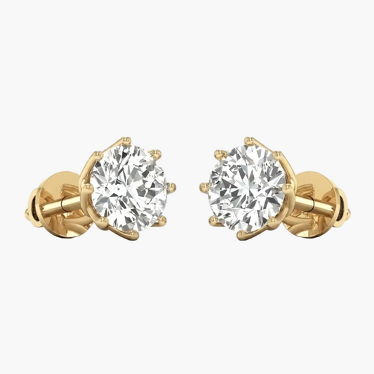 A pair of yellow gold stud earrings with round brilliant-cut clear gemstones in a prong setting, shown on a plain white background.