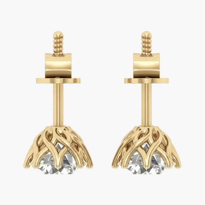 A pair of gold stud earrings with a floral or leaf-like openwork drop and a clear faceted gemstone at the bottom, shown on a plain white background.