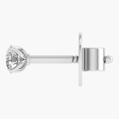 Silver earring with a clear gemstone on a white background