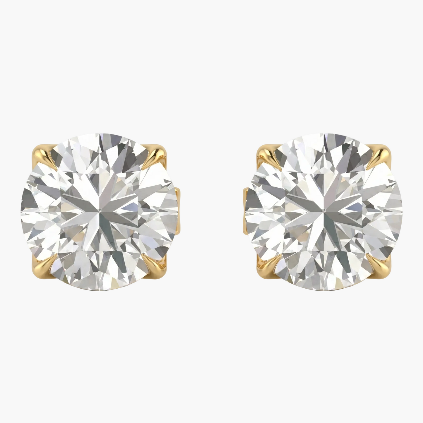 Pair of diamond stud earrings with gold prongs on a light gray background