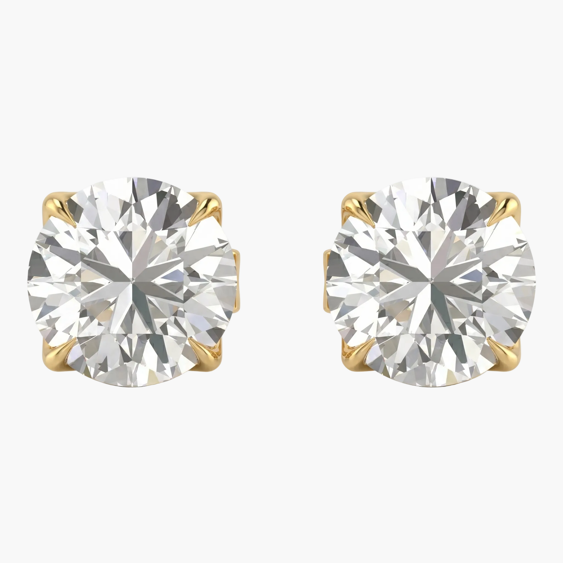 Pair of diamond stud earrings with gold prongs on a light gray background