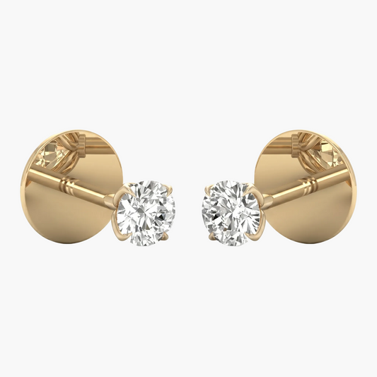 Gold earrings with clear gemstones on a white background