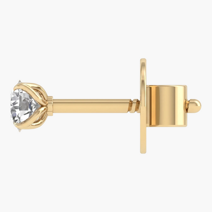 Gold earring with a clear gemstone on a white background