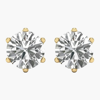 A pair of round-cut diamond stud earrings in yellow gold four-prong settings, shown on a plain white background.