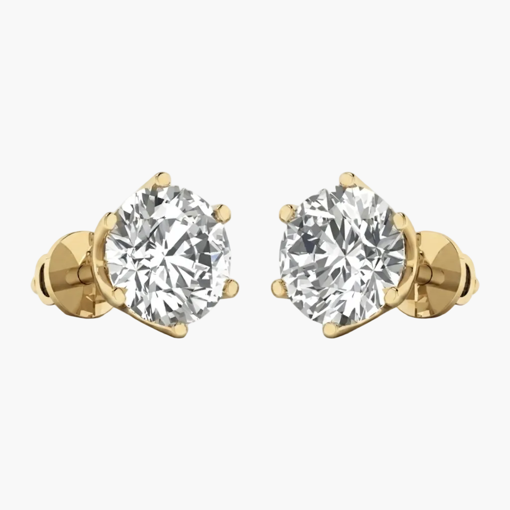 A pair of yellow gold stud earrings with large round brilliant-cut clear gemstones in a prong setting, shown on a plain white background.