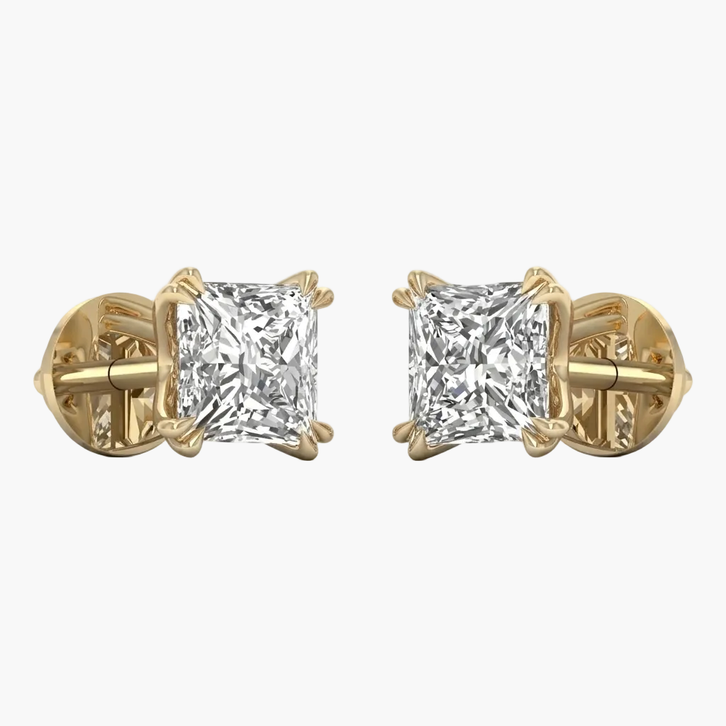 Gold earrings with clear gemstones on a white background