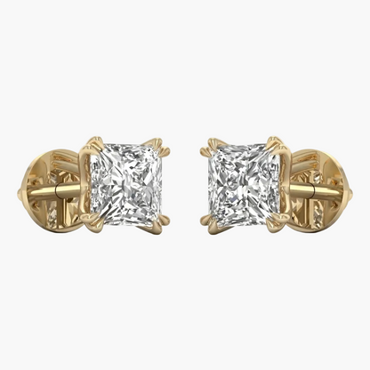 Gold earrings with clear gemstones on a white background
