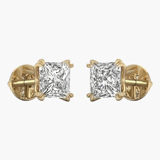 Gold earrings with clear gemstones on a white background