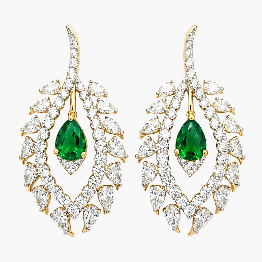 Pair of earrings with green gemstones and gold accents on a white background