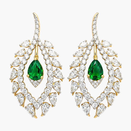 Pair of earrings with green gemstones and gold accents on a white background