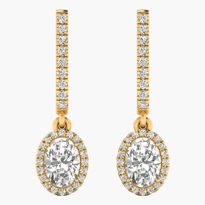 Gold earrings with large central gemstones and smaller stones on a white background
