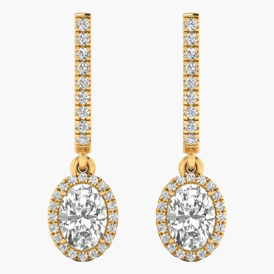 Gold earrings with large central gemstones and smaller stones on a white background