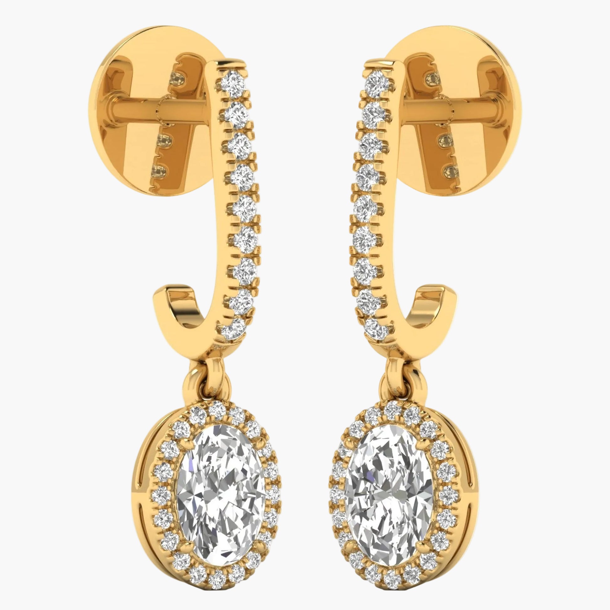 Gold earrings with clear gemstones on a white background
