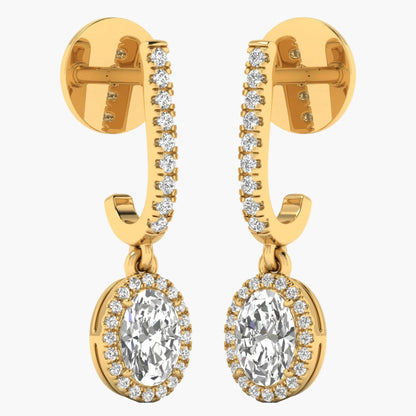 Gold earrings with clear gemstones on a white background