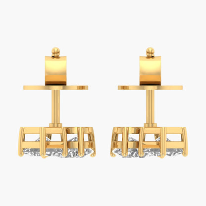 Pair of gold earrings with cylindrical tops on a white background
