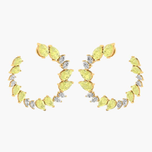 Gold earrings with yellow gemstones on a white background
