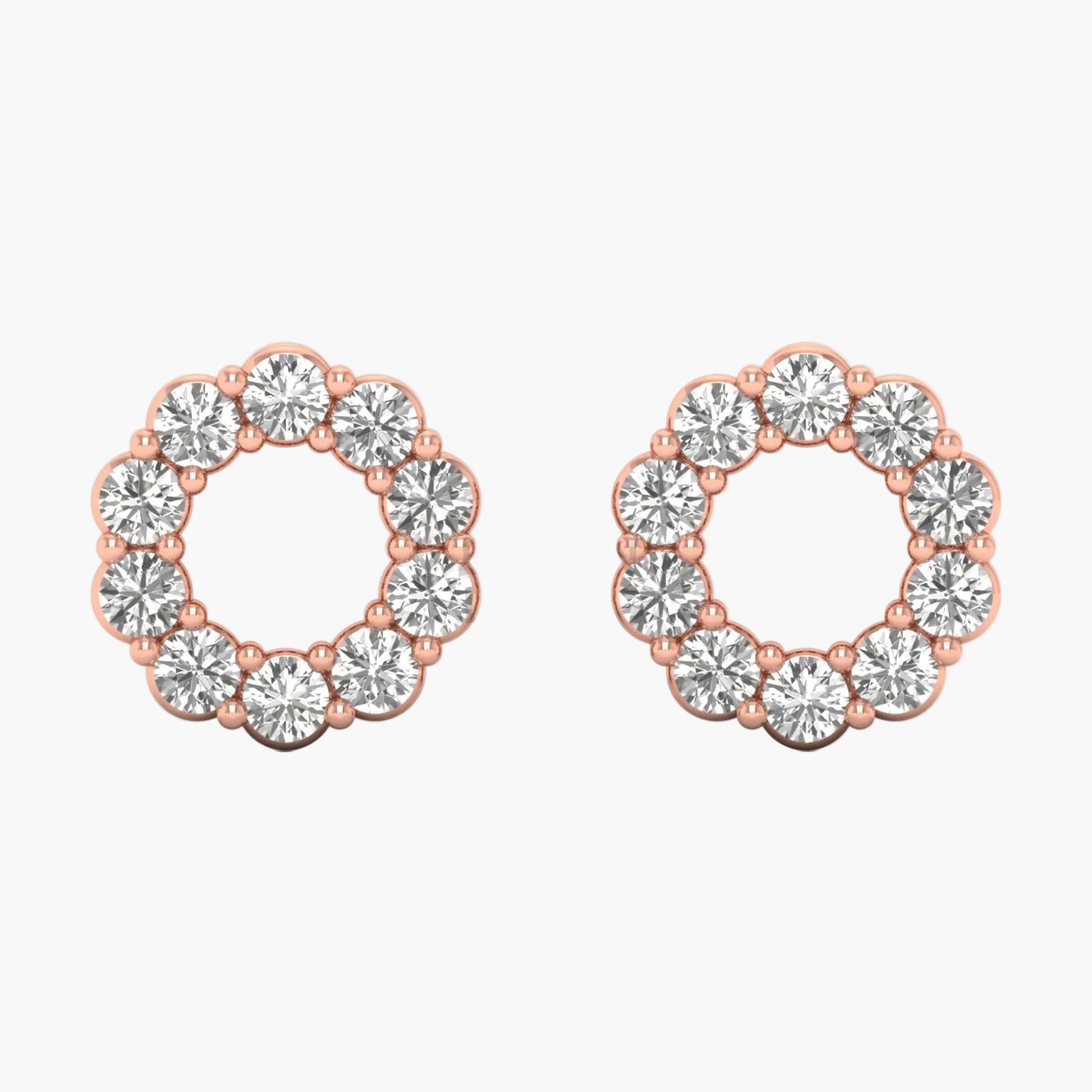 Pair of rose gold hoop earrings with clear gemstones on a white background