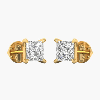 Gold earrings with clear gemstones on a white background