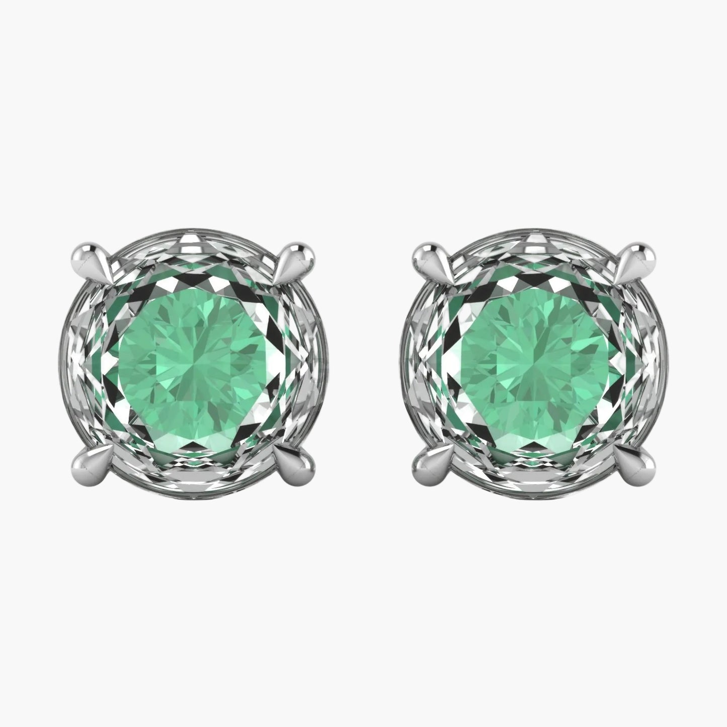 Pair of silver earrings with green gemstones on a white background