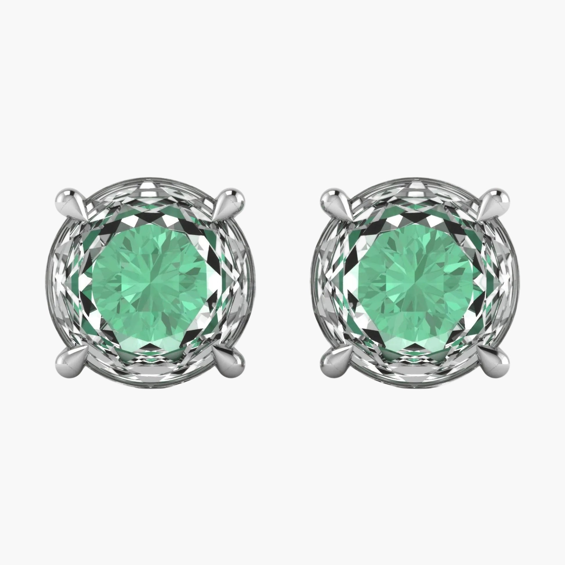 Pair of silver earrings with green gemstones on a white background