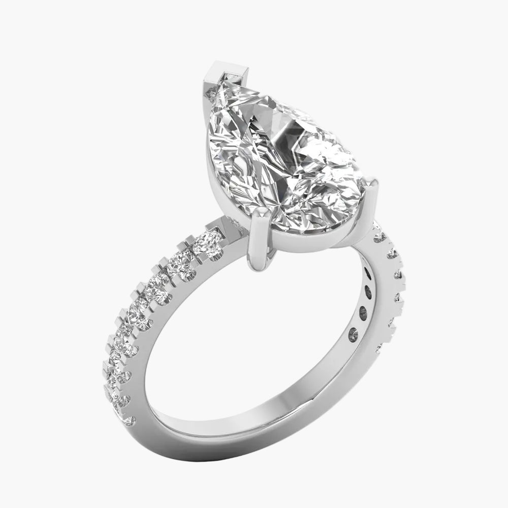 Diamond ring with a pear-shaped center stone on a white background