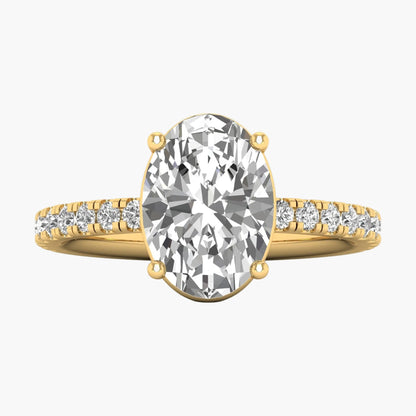 Gold ring with a large diamond and smaller diamonds on the band against a white background