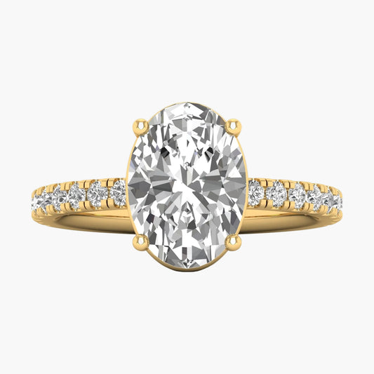 Gold ring with a large diamond and smaller diamonds on the band against a white background