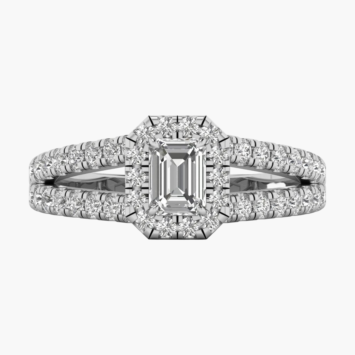 Diamond ring with emerald-cut center stone on a white background