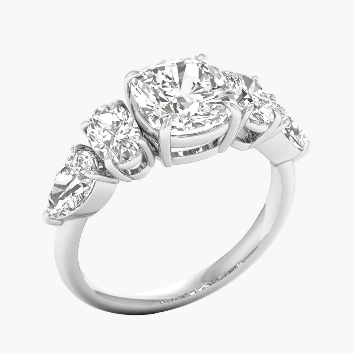 Diamond ring with four smaller diamonds on a white background