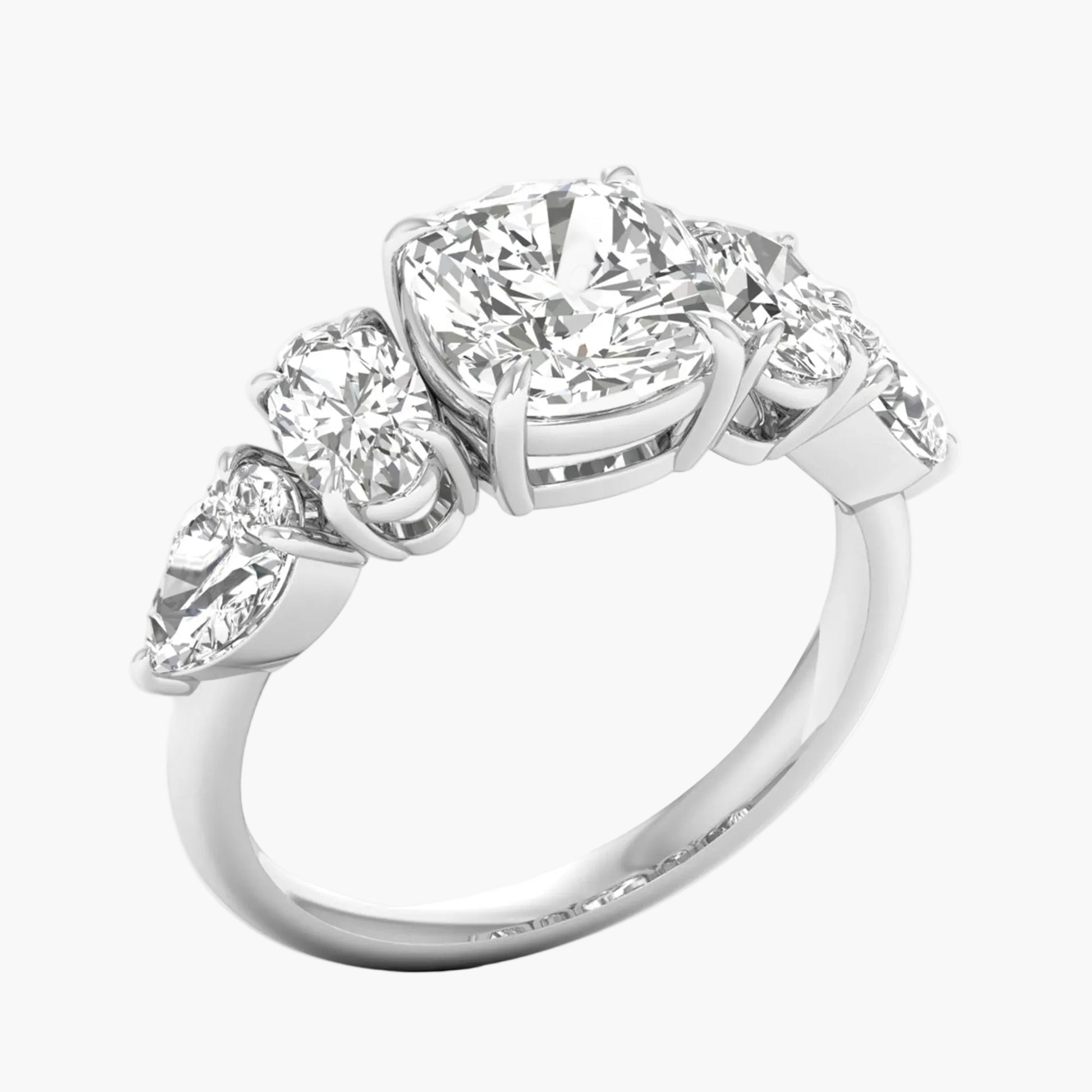 Diamond ring with four smaller diamonds on a white background