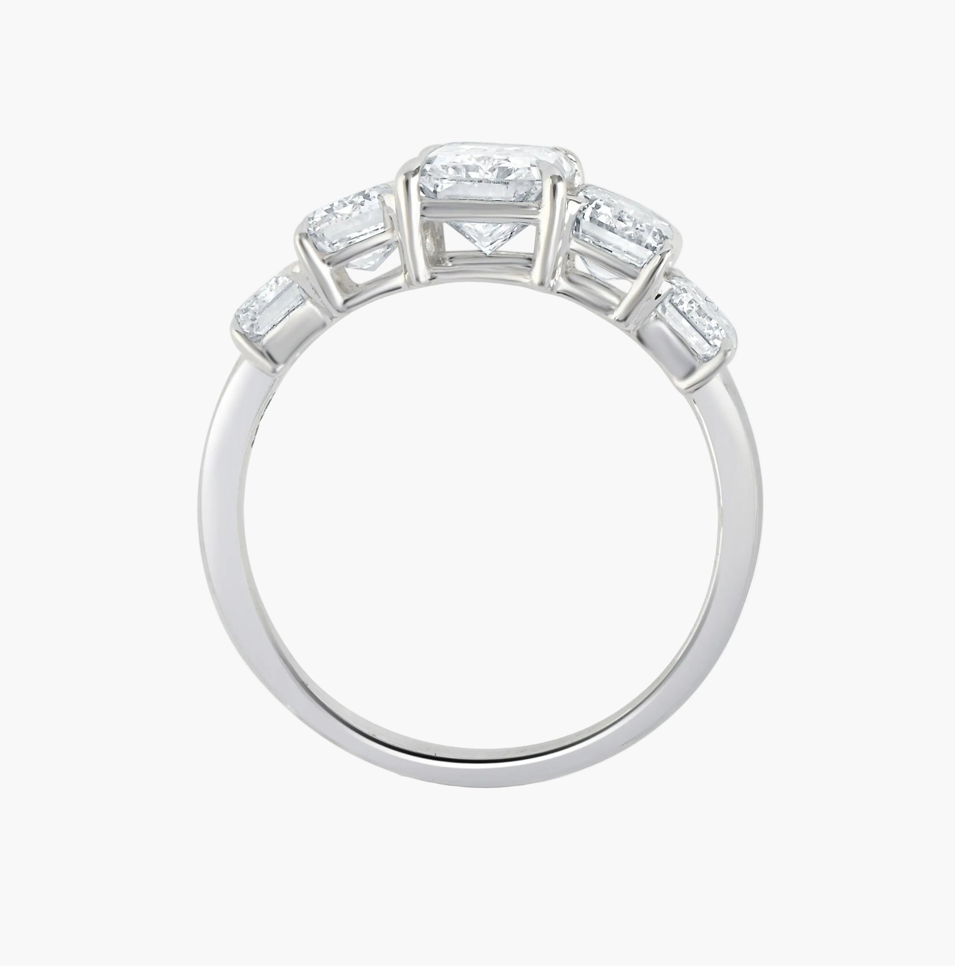 Diamond ring with baguette and princess cut stones on a white background