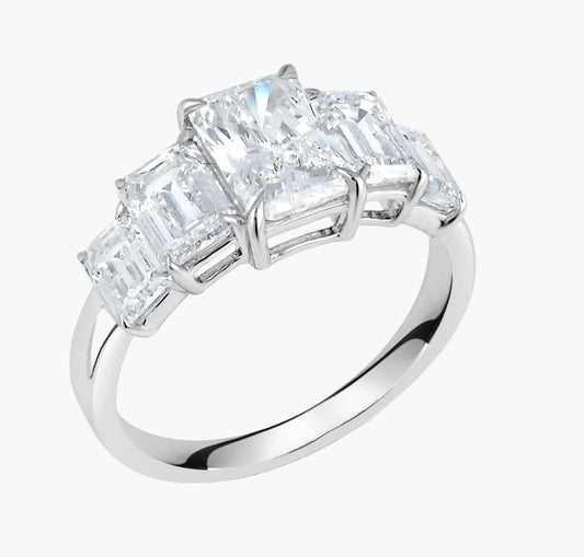Diamond ring with four-prong setting on a white background
