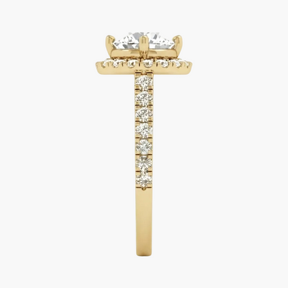A yellow gold ring featuring a large round-cut diamond center stone, a halo of small diamonds, and a pavé diamond band, shown on a plain white background.