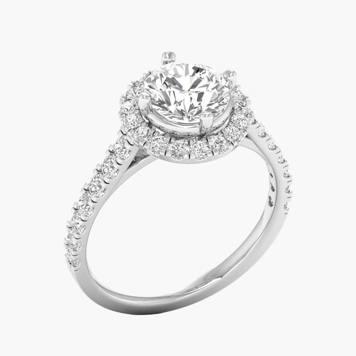 Diamond ring with a halo and round center stone on a white background
