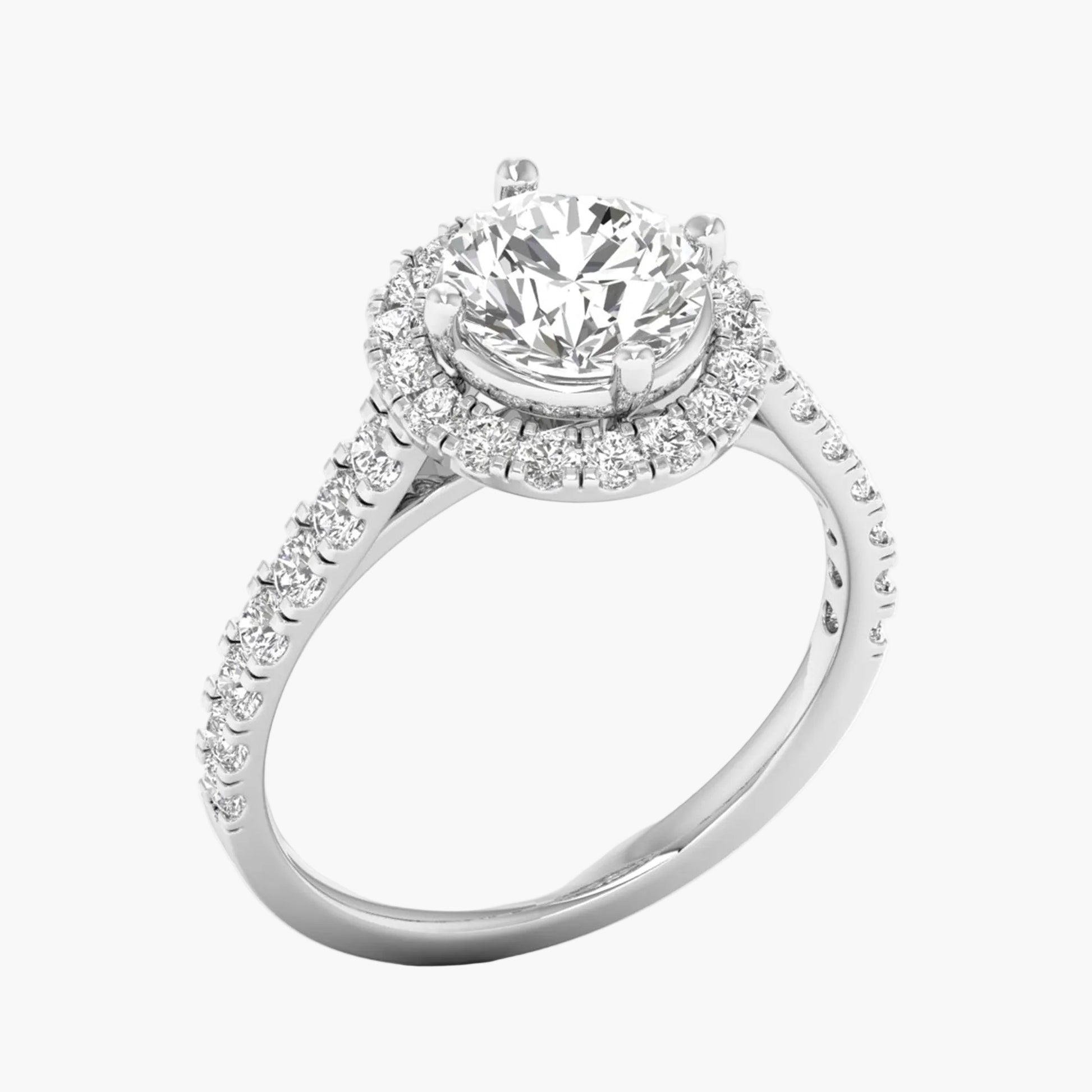 Diamond ring with a halo and round center stone on a white background