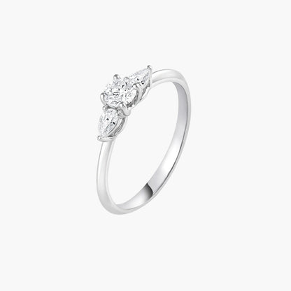 Silver ring with three diamond stones on a white background