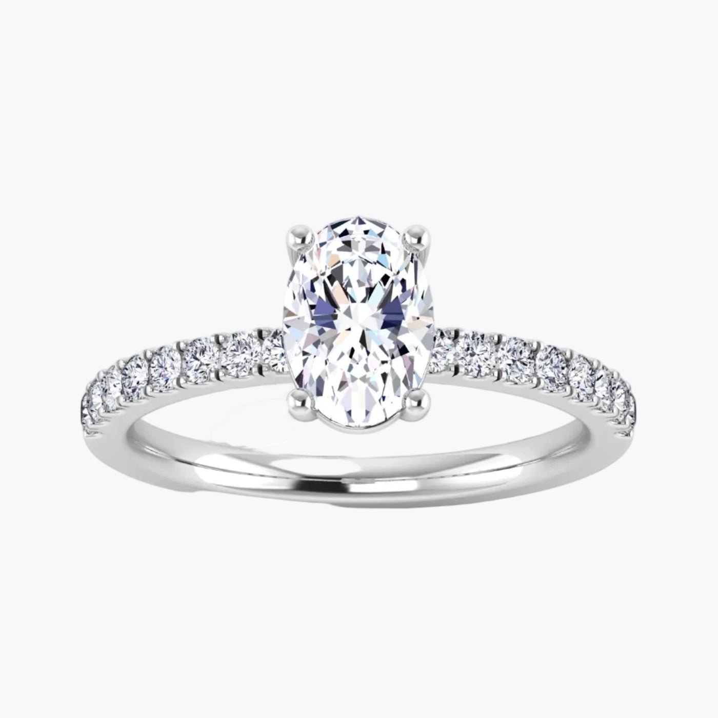 Diamond ring with a central oval-cut diamond and smaller diamonds on the band against a white background