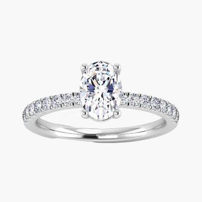 Diamond ring with a central oval-cut diamond and smaller diamonds on the band against a white background